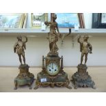 A late 19thC French gilt metal and onyx clock garniture, surmounted by figures; the bell strike