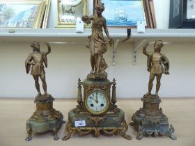 A late 19thC French gilt metal and onyx clock garniture, surmounted by figures; the bell strike