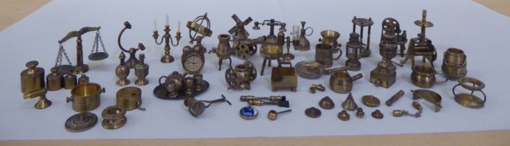 A miscellany of white metal and brass miniature engineered artefacts: to include furniture; weighing