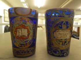 A pair of 19thC Continental blue glass beakers of tapered form, similarly overpainted and gilded