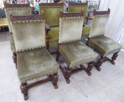 A set of six 1920s carved oak framed dining chairs with green fabric stud upholstered, cushioned