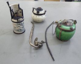 Three various antique Oriental ceramic and metal mounted burners; and a novelty opium pipe