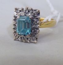 An 18ct gold rectangular cluster ring, set with diamonds and a blue stone