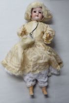 An early 20thC Max Oscar Arnold Welsch bisque head doll with painted features, on a jointed