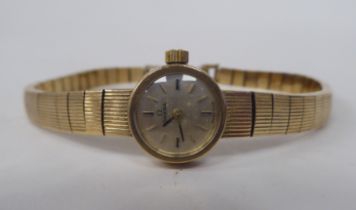 A ladies Omega 9ct gold cased bracelet wristwatch, faced by a baton dial