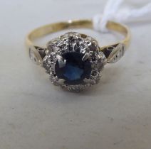 An 18ct gold diamond and sapphire cluster ring