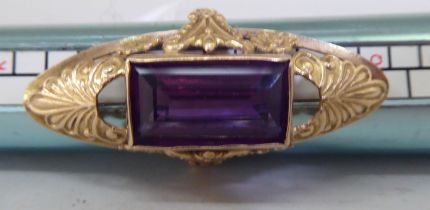 A 13ct gold marquise design ring, set with a purple stone