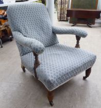 A late Victorian walnut showwood framed chair, in the style of Howard, later upholstered in