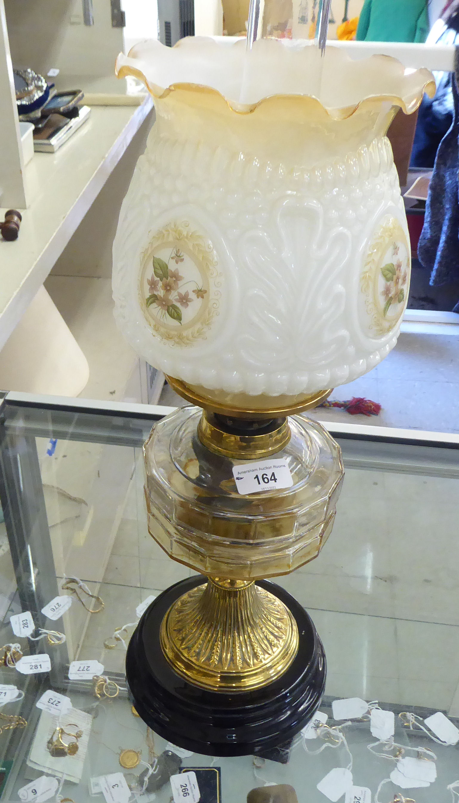 A late Victorian brass oil lamp with a moulded glass reservoir, on a pedestal base and black ceramic - Image 2 of 2