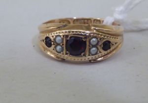 A 9ct gold garnet and seed pearl ring