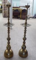 A pair of modern ecclesiastically inspired brass pricket candlestands  36"h