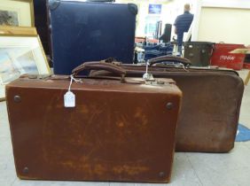 An S Globetrotter overnight case, on casters  25"w; a moulded, stitched brown hide suitcase  20"w;