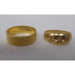 An 18ct gold rubover set, three diamond ring; and an 18ct gold, textured band ring