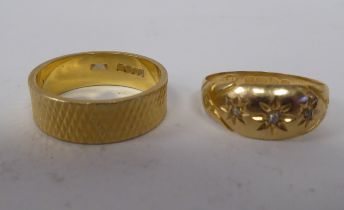 An 18ct gold rubover set, three diamond ring; and an 18ct gold, textured band ring