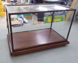 A modern fully glazed mahogany display case with a removeable top, on a platform and bun feet  12" x