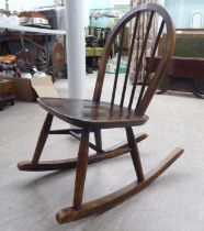 A child's Ercol dark stained beech framed hoop and spindle back rocking chair