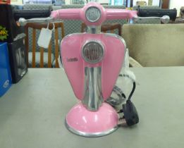 A painted cast metal table lamp, fashioned as the front of a Lambretta scooter  11"h