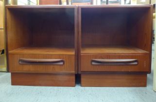 A pair of G-Plan teak bedside cabinets, each with an open shelf and single drawer, on a plinth  20"h