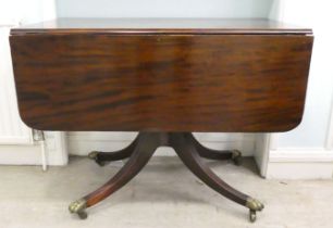 A Regency mahogany Pembroke table, raised on reeded sabre legs and brass casters  29"h  38"w