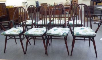 A set of eight Ercol beech and elm framed spindled high hoop back dining chairs, raised on turned