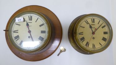 Two Smiths Astral brass cased bulkhead timepieces with painted Roman dials, one mounted on a plaque