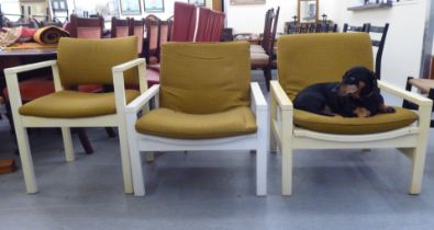 Three 1960s Cornwell-Norton cream painted open arm chairs with original mustard coloured fabric