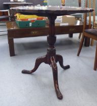 A late Victorian mahogany tip-top pedestal table, raised on a tripod base with carved cabriole legs