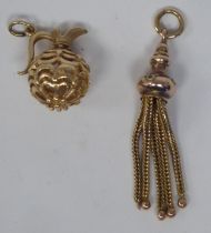 Two gold coloured metal charms, viz. a miniature ewer; and a tasselled pendant
