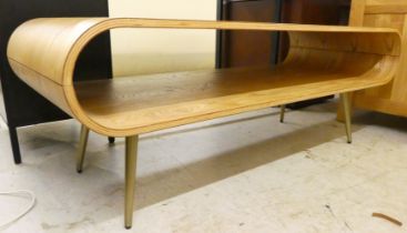 A modern curved pine effect coffee table, raised on tapered legs  17"h  47"w