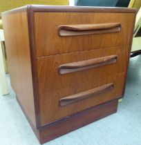 A G-Plan teak bedside chest with three drawers, on a plinth  21"h  19"w