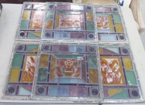 Six stained and leaded glass panels, each decorated with floral images  15.5" x 15.5"  framed