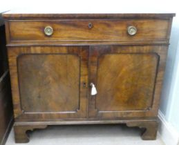 A Regency mahogany sideboard with a drawer and two panelled doors, raised on bracket feet  35"h