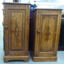 Two similar late Victorian painted pine bedside cabinets, each with a single door, on a plinth  31"h