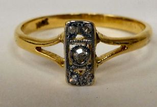 A yellow metal ring, set with five diamonds, arranged on a central bar  stamped 18ct