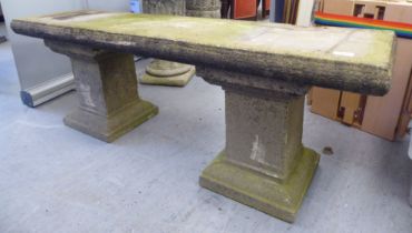 A three part composition stone garden bench, raised on block pedestals  52"w