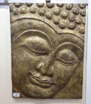 A modern gilt sprayed and moulded composition plaque, the face of a Buddha  17.5" x 23"