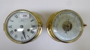 A lacquered brass cased bulkhead 8 day timepiece; and similar barometer  each 7"dia