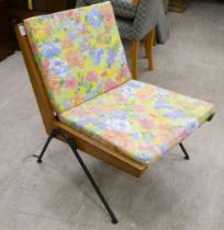 A 1970s teak framed easy chair with webbing supports and splayed legs