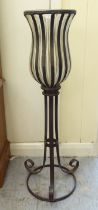 A modern wrought metal framed candlestand with a glass bowl  32"h