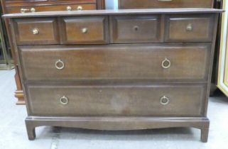 A Stag mahogany six drawer dressing chest, raised on bracket feet  28"h  42"w