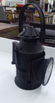 A reproduction of a vintage black painted iron railway signal lamp  12"h