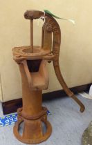 A rust coloured cast iron replica of a 19thC water pump head  21"h
