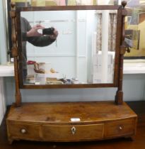 A Regency mahogany toilet mirror, pivoting on turned horns, on a box base with three drawers  25"