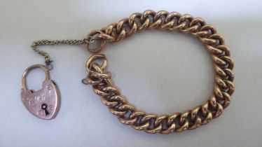 A 9ct gold bracelet with a heart shaped padlock clasp