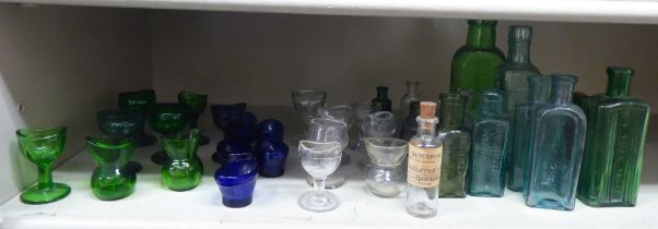 Coloured glass chemist bottles and eye baths  largest 6"h