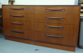 A G-Plan teak dressing chest with two banks of four drawers, on a plinth  28"h  55"w