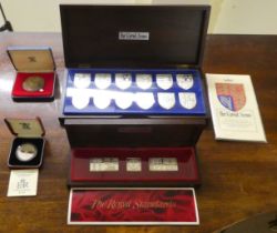 Four silver and white metal coins; and other presentation sets: to include a set of twelve Royal