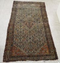 A Persian rug, decorated with floral motifs, on a brown ground  79" x 42"