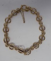 A 9ct gold ring link bracelet, on a ring bolt clasp and safety chain