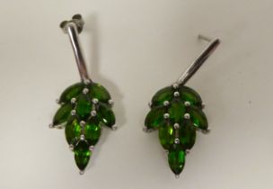 A pair of white metal earrings, fashioned as leaves, set with green stones  stamped 925